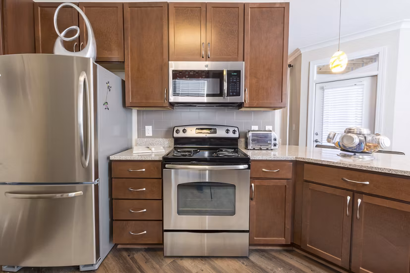 Modern kitchen with stainless steel appliances at Morgan Reserve Apartments offers luxury living in a Greystar community