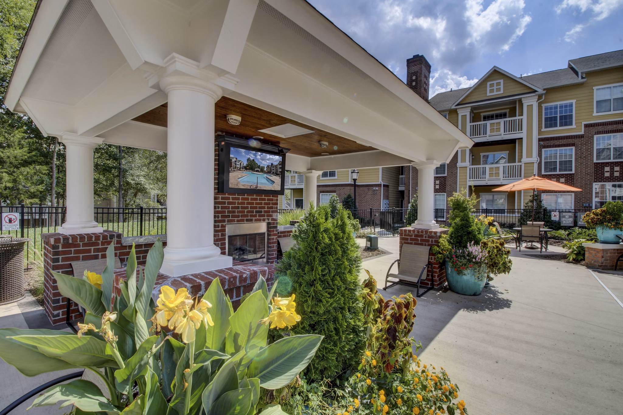 Patio with comfortable seating and lush greenery at Morgan Reserve Apartments