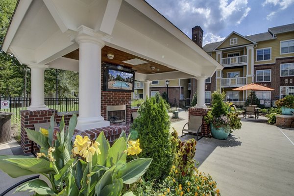 Patio with comfortable seating and lush greenery at Morgan Reserve Apartments