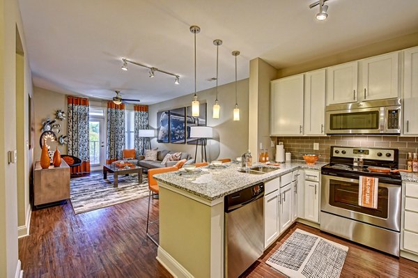 Contemporary kitchen with modern appliances at Yards at Noda Apartments