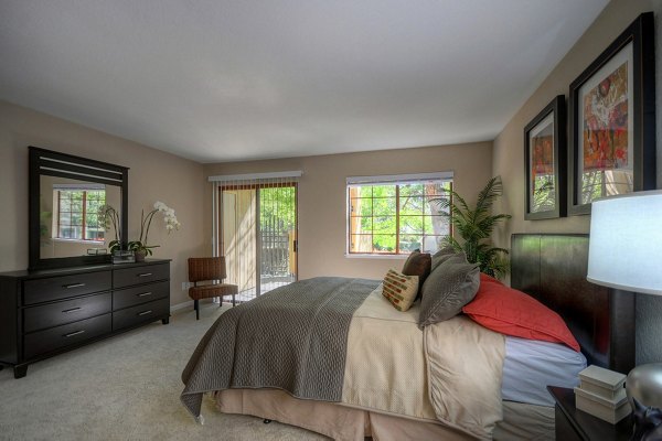 Cozy bedroom with modern decor at Canyon Woods Apartments, featuring luxury living and comfort in a serene setting