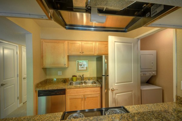 Modern kitchen with granite countertops and stainless steel appliances at Canyon Woods Apartments Luxury living in a Greystar community
