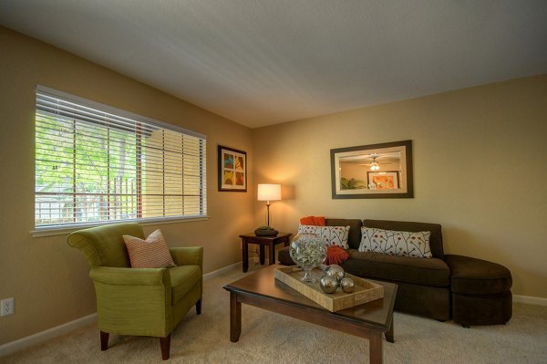 Living room with modern furnishings at Canyon Woods Apartments, Greystar luxury apartments in a serene wooded setting