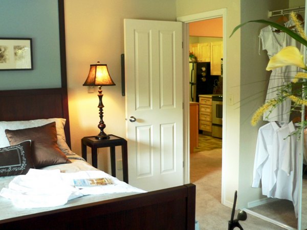 Cozy bedroom with stylish decor at Hampton Greens Apartments