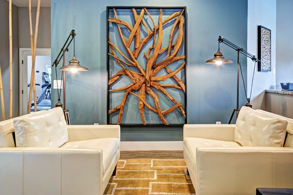 Spacious clubhouse with modern seating and game areas at Hampton Greens Apartments luxury community