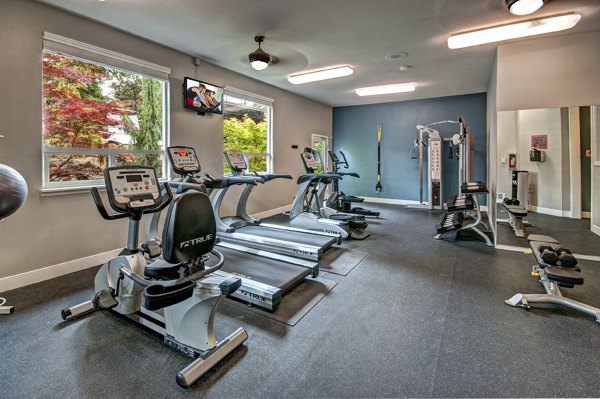 State-of-the-art fitness center equipped with modern exercise machines at Hampton Greens Apartments