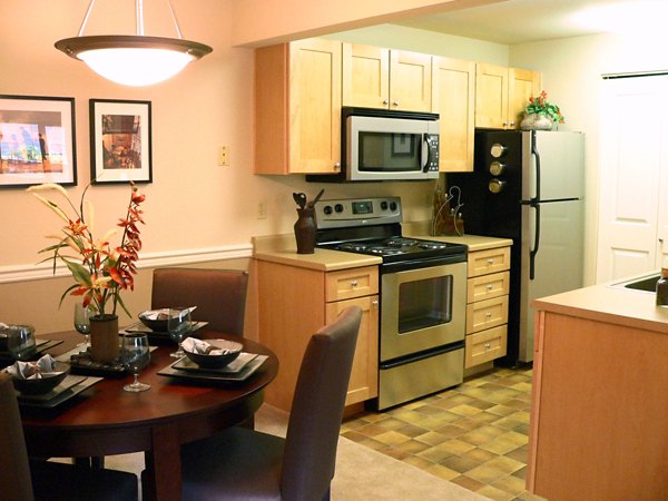 Modern kitchen with granite countertops and stainless steel appliances in Hampton Greens Apartments