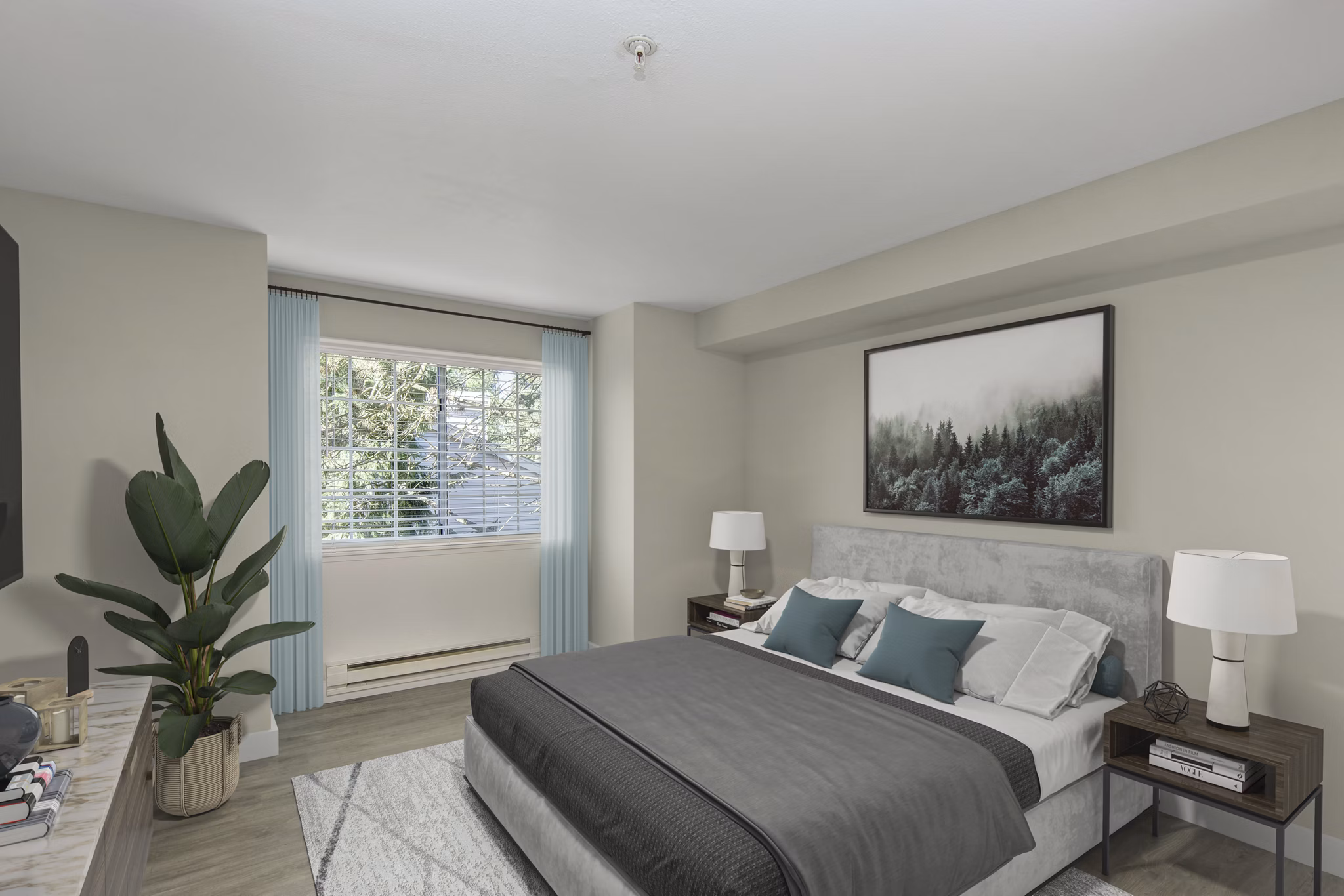 Cozy bedroom with modern decor at BluWater Apartments, featuring plush bedding and ample natural light