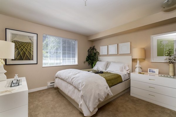 Spacious bedroom with modern design elements in BluWater Apartments, featuring luxury amenities and serene views