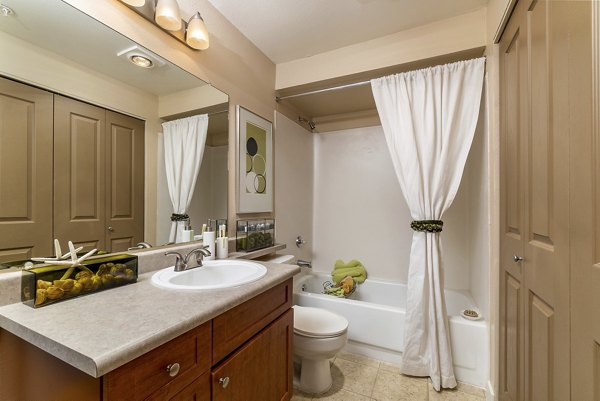 Modern bathroom with marble countertops and glass shower at BluWater Apartments' luxury residences
