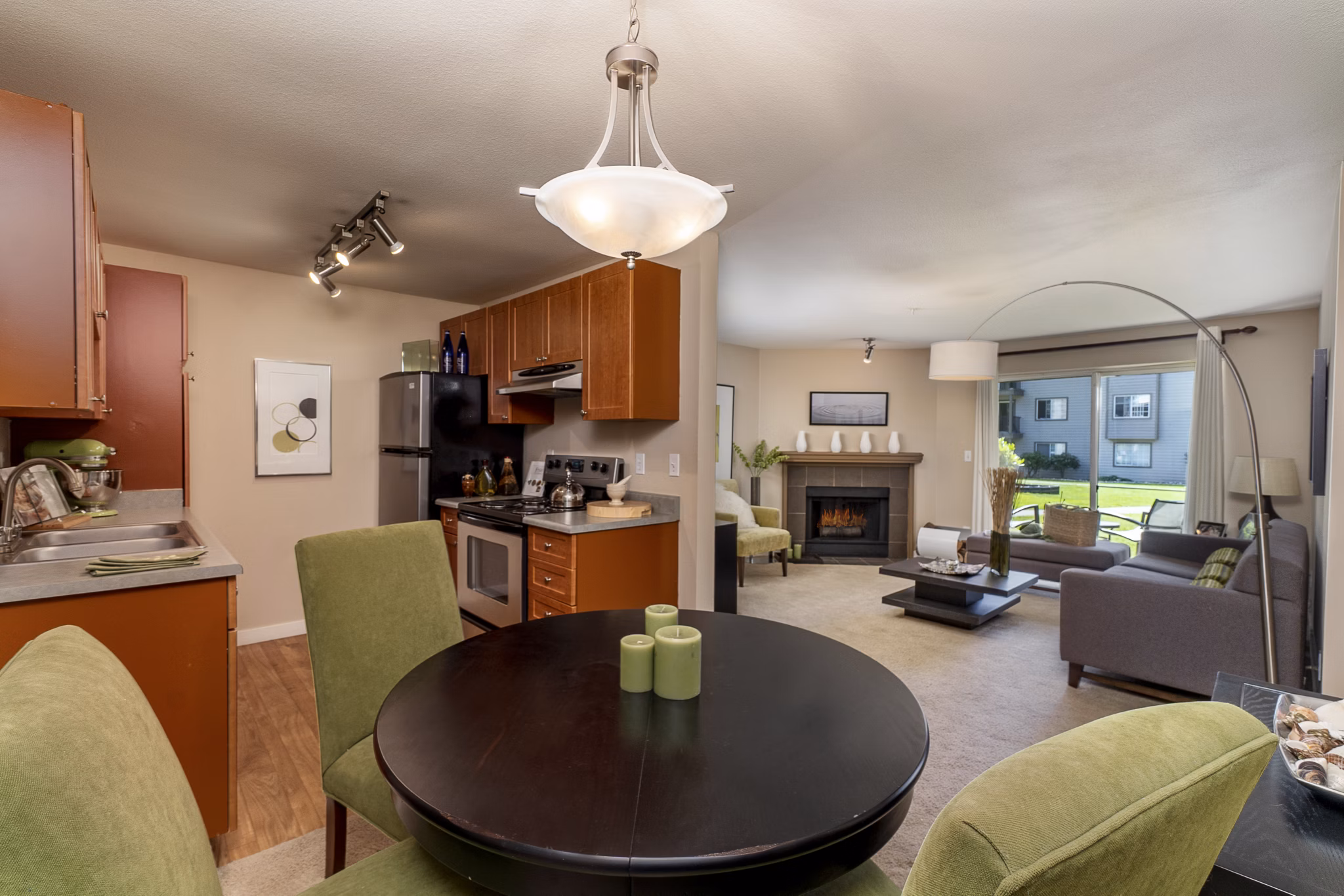 Dining area designed with modern furnishings and sleek lighting in BluWater Apartments, creating an inviting space for residents to enjoy meals together