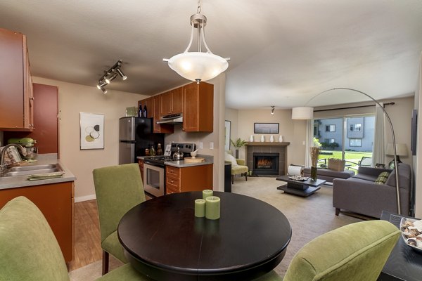 Dining area designed with modern furnishings and sleek lighting in BluWater Apartments, creating an inviting space for residents to enjoy meals together