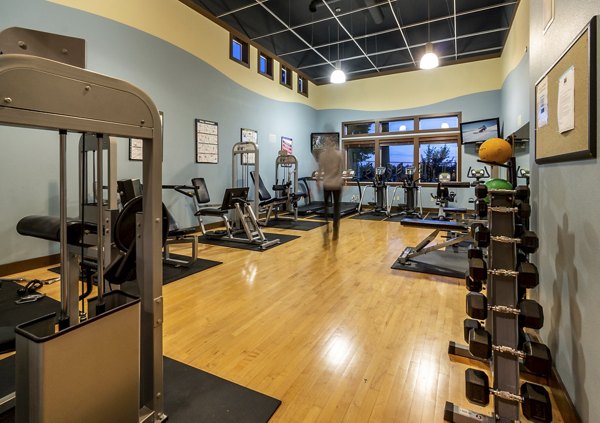 Fitness center with modern equipment at BluWater Apartments, offering a spacious gym environment for residents to stay active and healthy