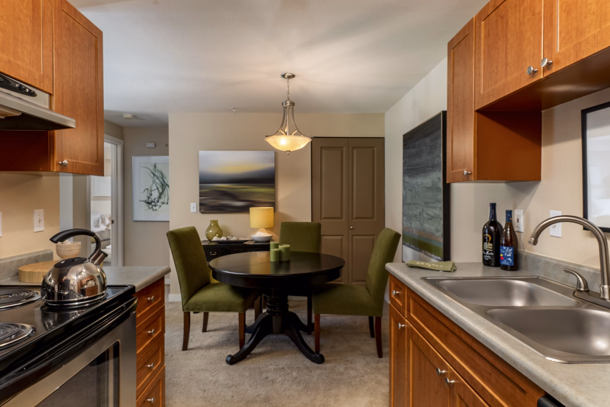 Modern kitchen with stainless steel appliances in BluWater Apartments