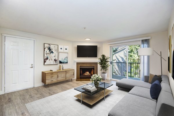 Living room featuring modern furnishings and large windows at BluWater Apartments, Greystar luxury apartments