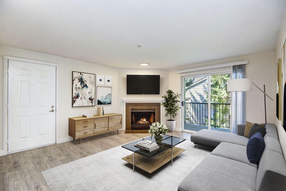 Living room featuring modern furnishings and large windows at BluWater Apartments, Greystar luxury apartments
