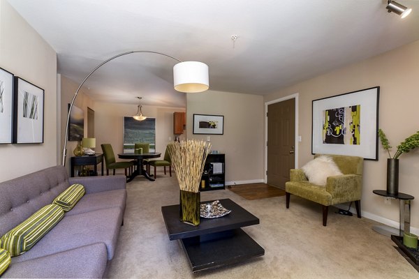 Modern living room with stylish decor and large windows in BluWater Apartments