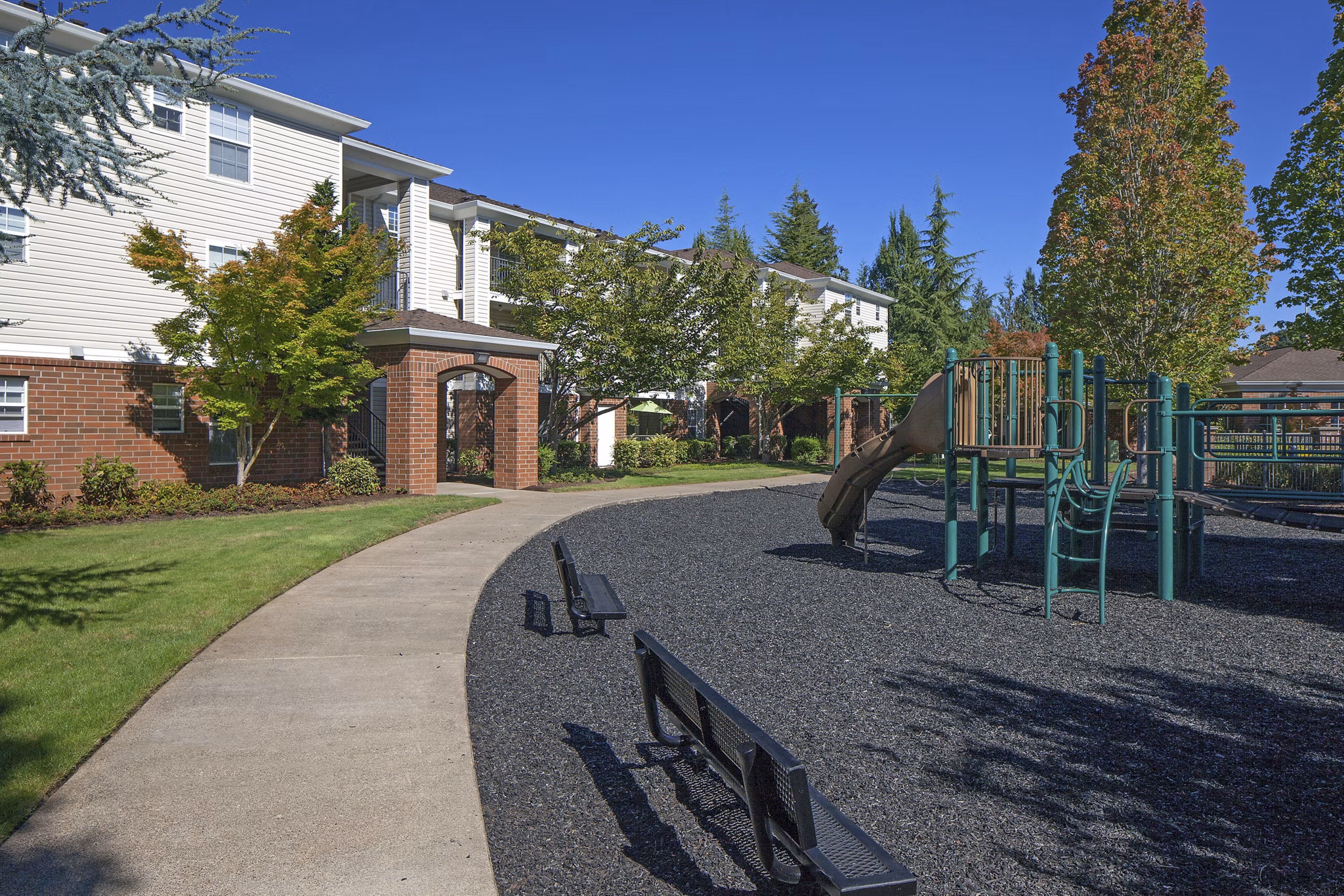 Children's playground with slides and swings at Arya at Hedges Creek Apartments, offering family-friendly amenities in a vibrant community setting