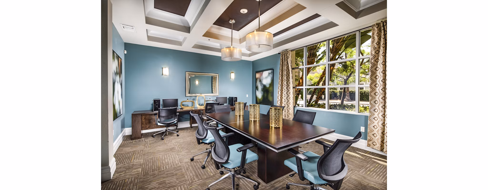 Meeting facility with modern seating and large presentation screen at Allure Apartments