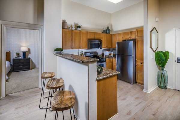 Dining room with modern furnishings and elegant lighting at Allure Apartments