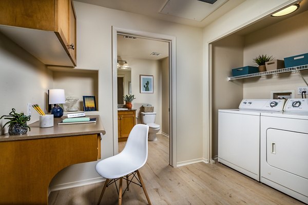 Laundry room featuring modern appliances in Allure Apartments