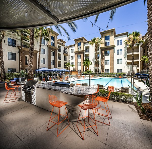 Outdoor grilling area with modern barbecue stations at Allure Apartments