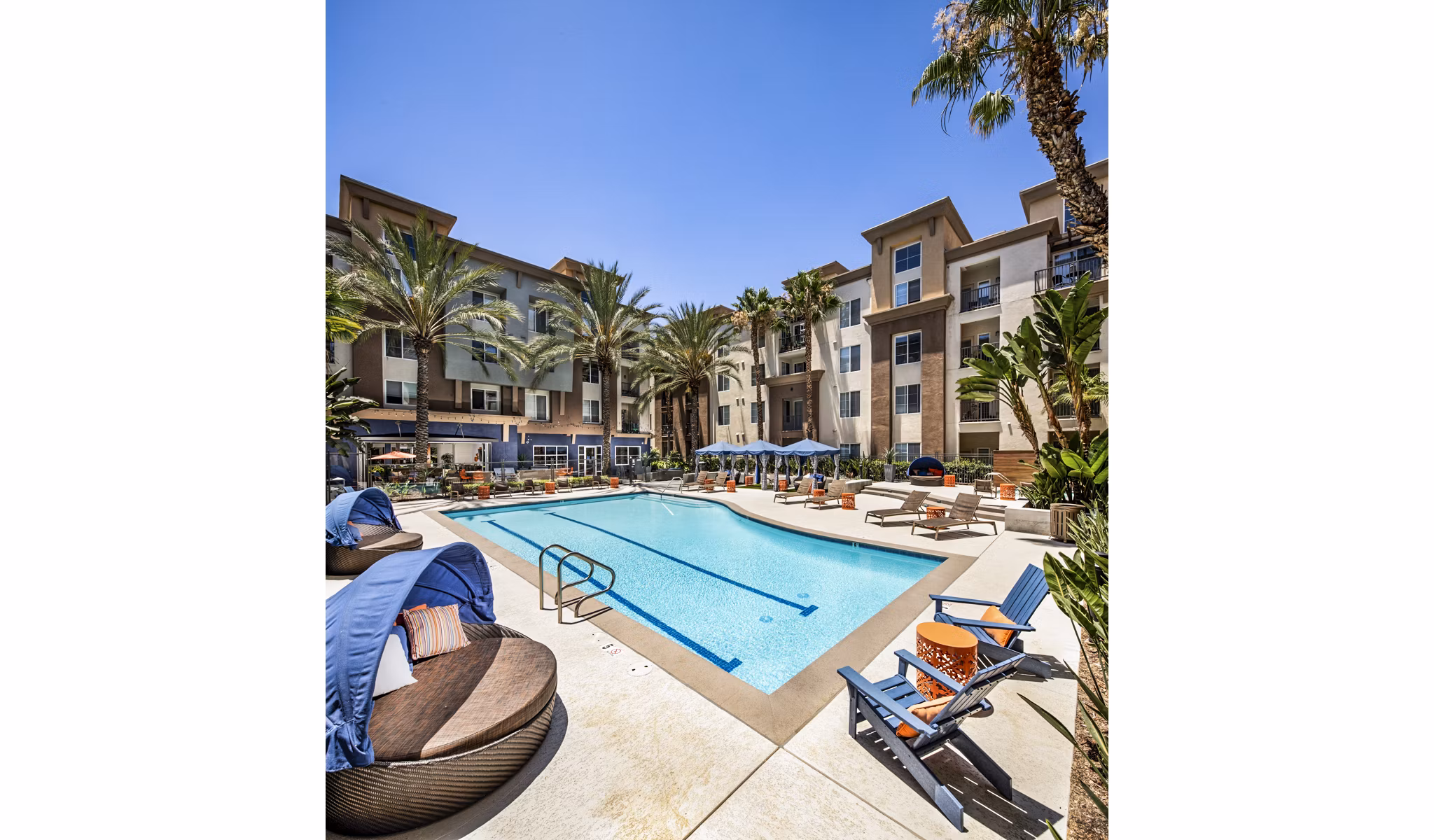 Inviting pool area at Allure Apartments, featuring modern lounge chairs and lush landscaping
