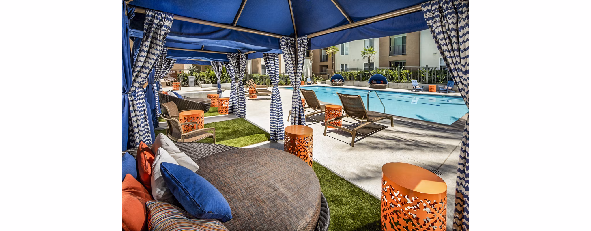 Stunning pool with lounge chairs at Allure Apartments, providing relaxation in a luxurious setting