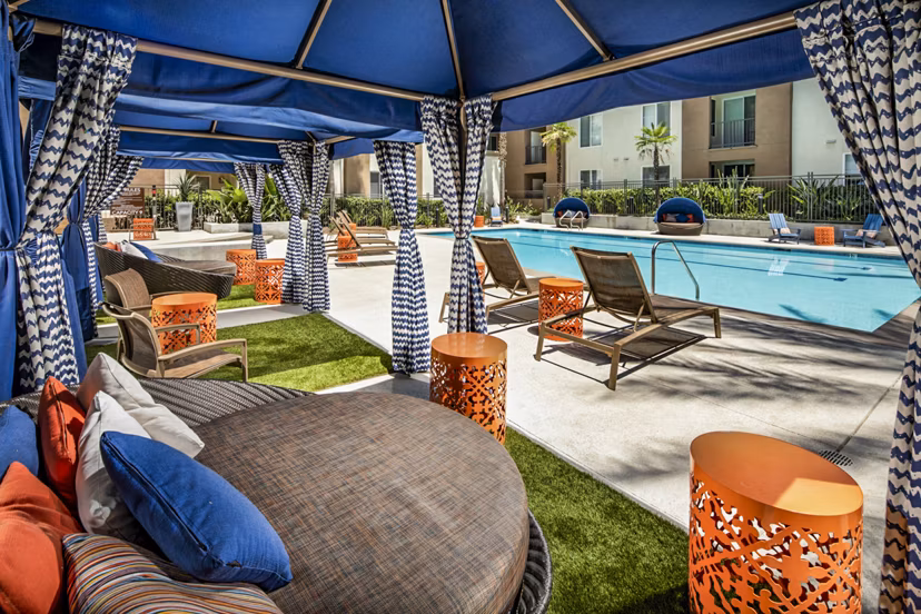 Stunning pool with lounge chairs at Allure Apartments, providing relaxation in a luxurious setting