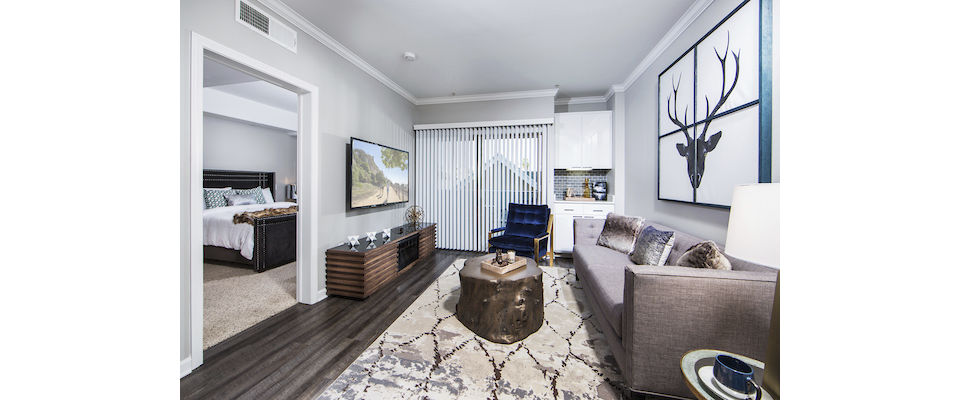 Modern living room with sleek furnishings at Avana on Wilshire Apartments, highlighting luxury urban lifestyle in Los Angeles