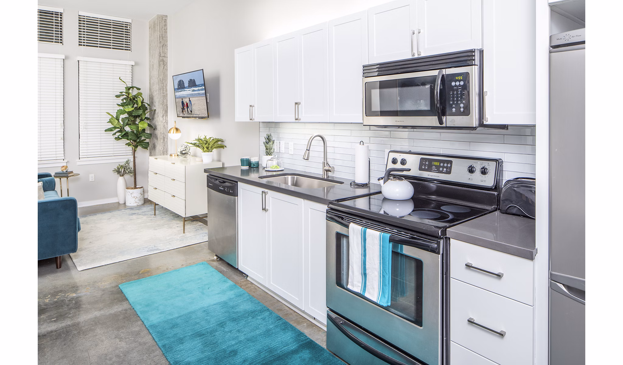 Sleek kitchen with modern appliances and granite countertops at Park 19 Apartments in Portland