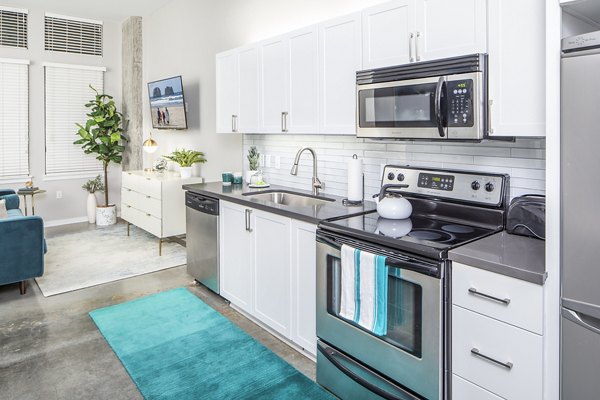 Sleek kitchen with modern appliances and granite countertops at Park 19 Apartments in Portland