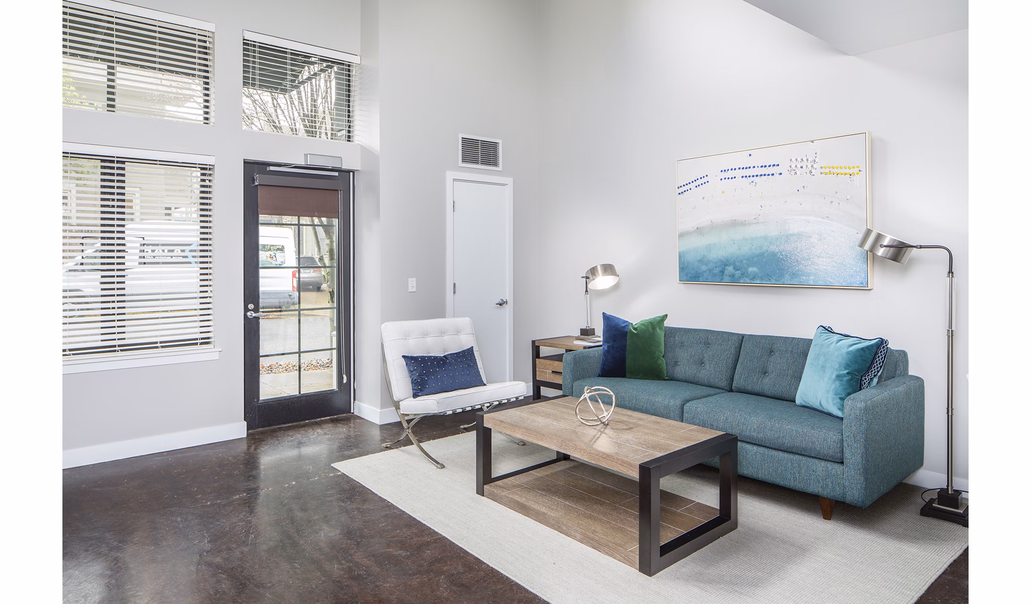 Living room with modern decor and large windows in Park 19 Apartments, offering luxury living in a serene environment