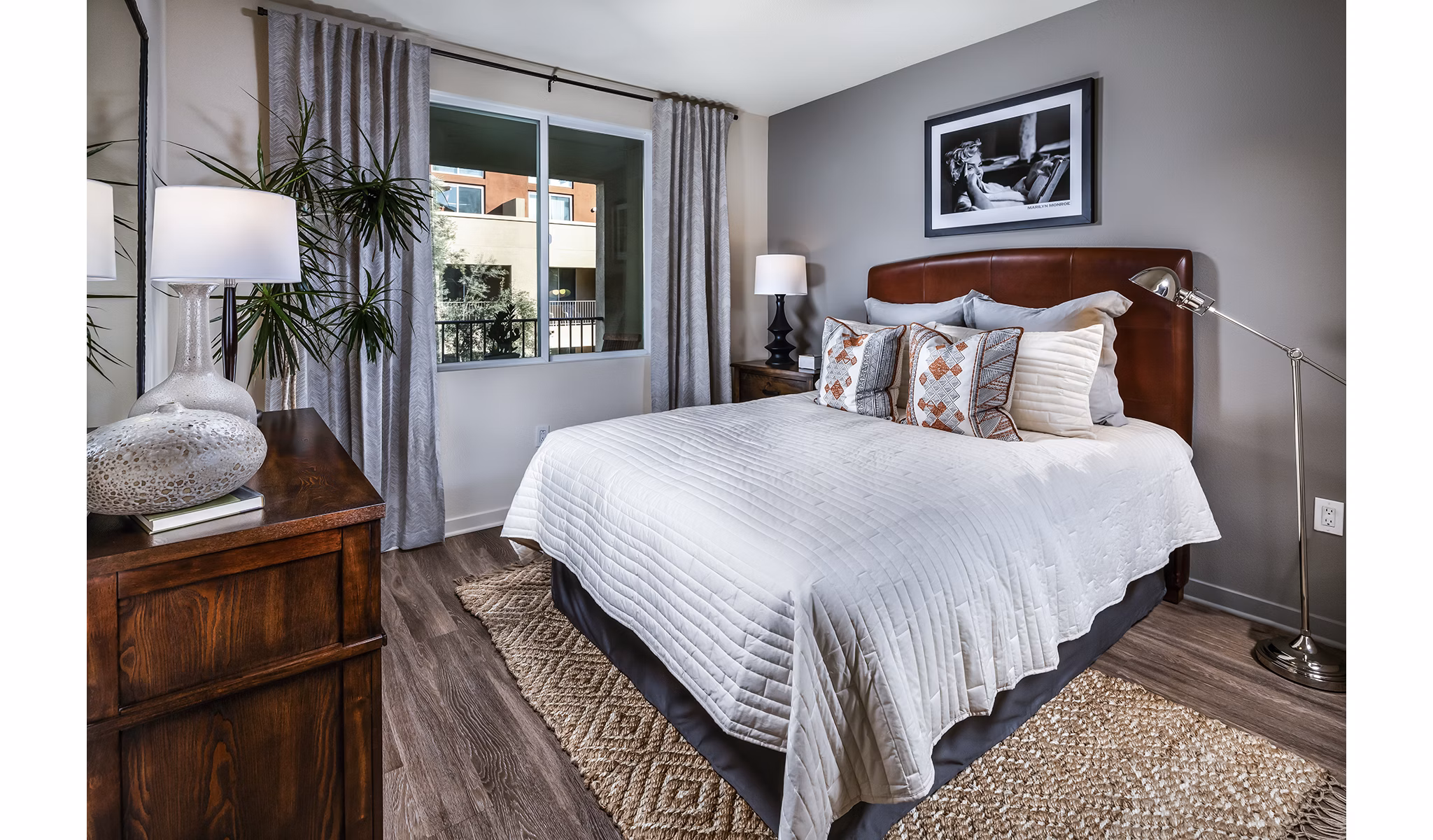 Trio Apartments: Cozy bedroom with modern furnishings and natural light