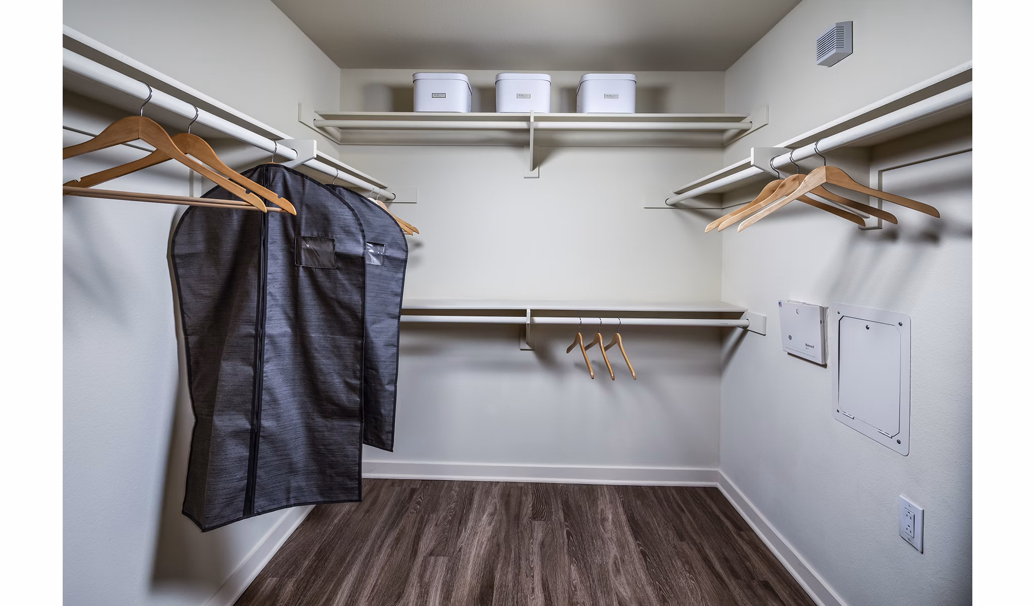Cozy bedroom with modern decor at Trio Apartments featuring plush bedding and ample natural light