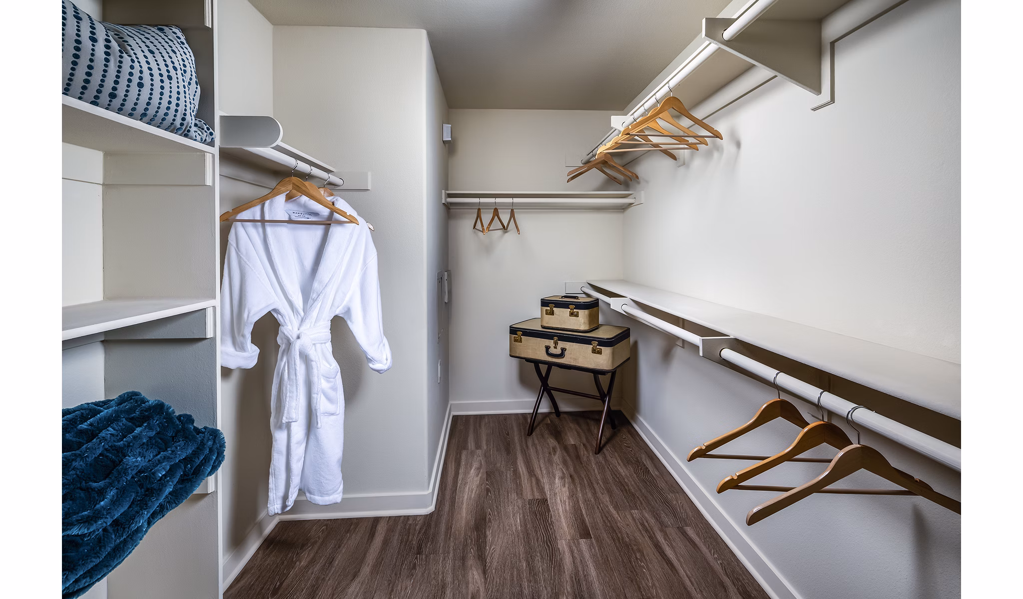 Walk-in closet with ample shelving in master bedroom at Trio Apartments, a luxury Greystar property