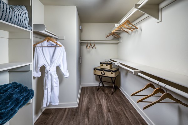 Walk-in closet with ample shelving in master bedroom at Trio Apartments, a luxury Greystar property