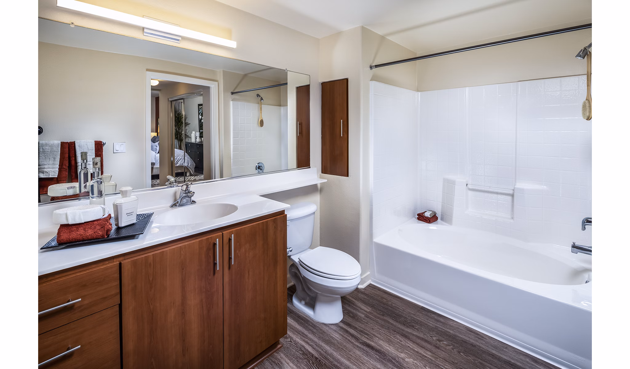 Modern bathroom featuring marble countertops and glass shower in Trio Apartments