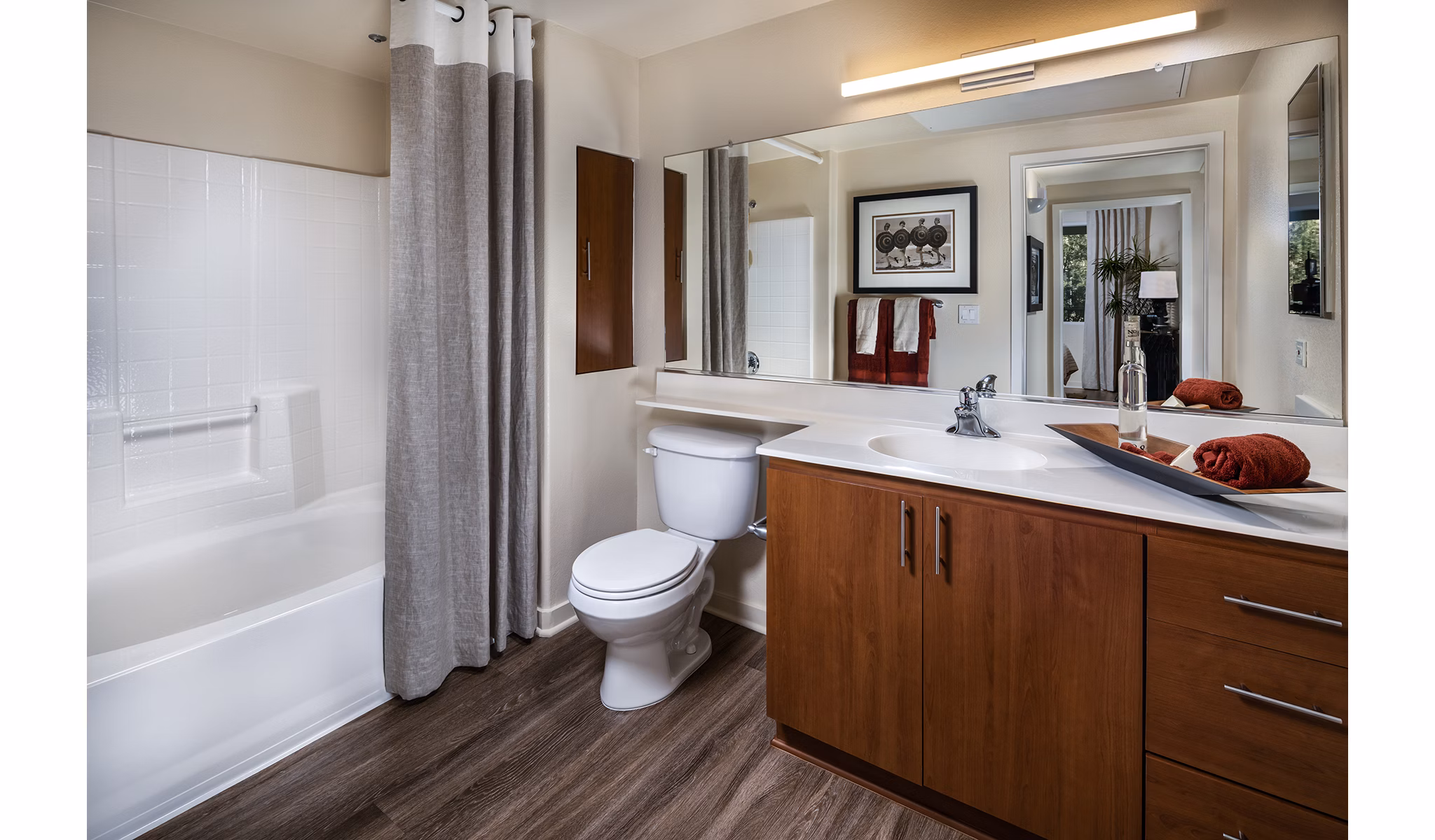 Modern bathroom featuring sleek fixtures and glass shower in Trio Apartments