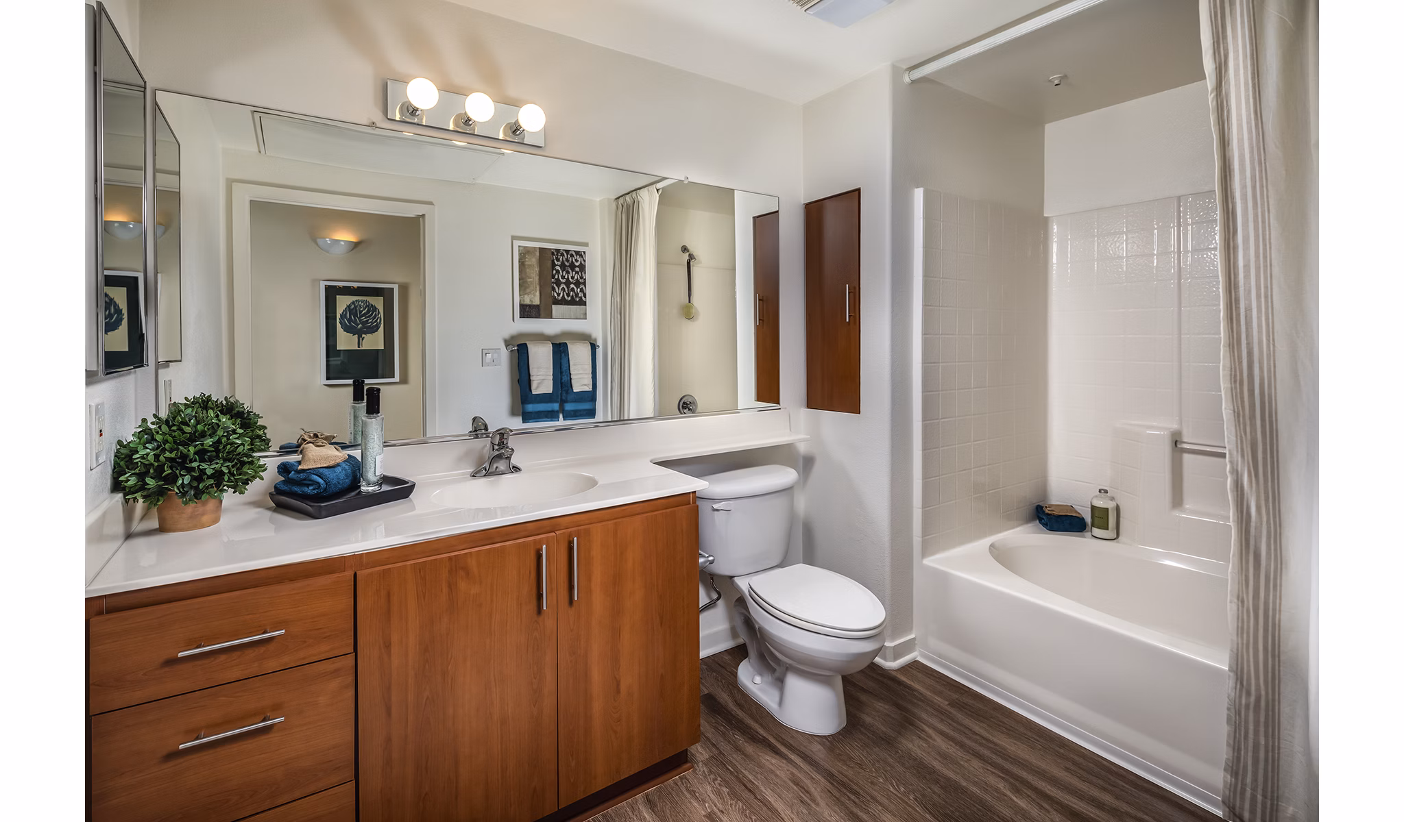 Luxurious bathroom with marble countertops and elegant fixtures at Trio Apartments