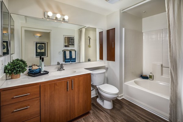 Luxurious bathroom with marble countertops and elegant fixtures at Trio Apartments