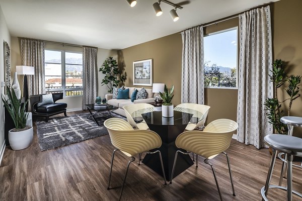 Dining room featuring elegant lighting and modern furnishings at Trio Apartments