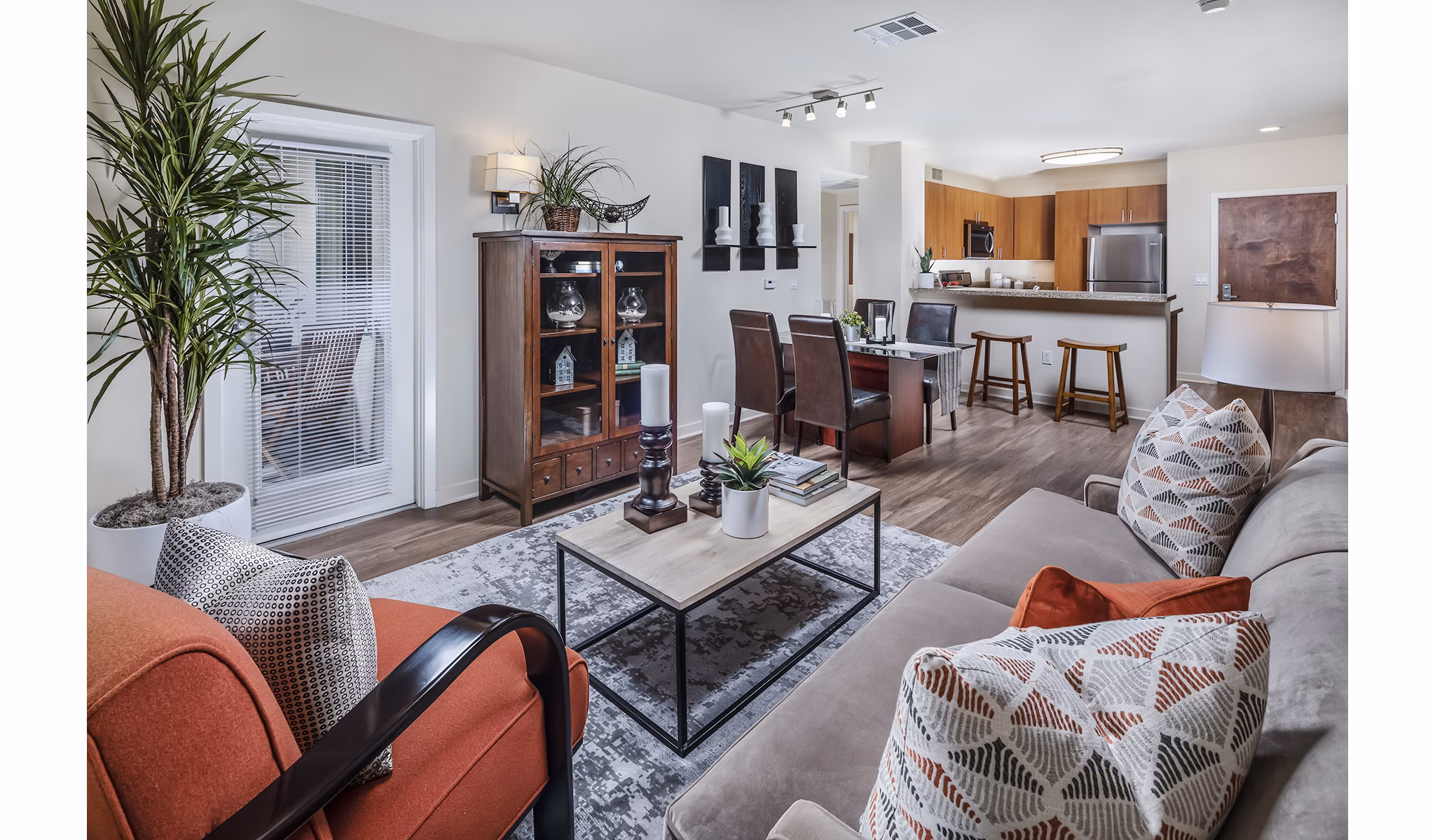 Spacious living room with modern furnishings at Trio Apartments, showcasing luxury style and comfort