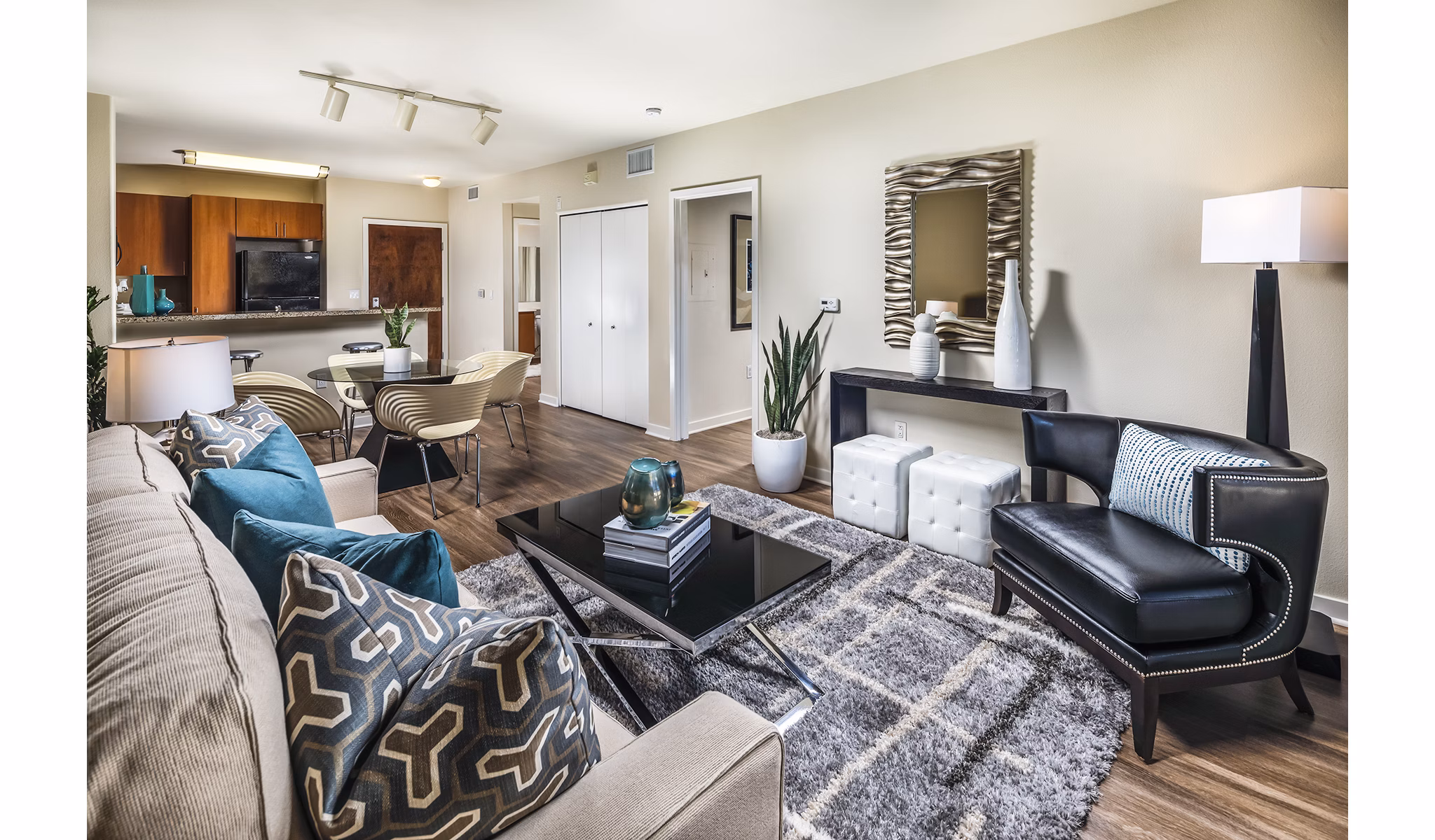 Spacious living room with modern decor and natural light at Trio Apartments, offering luxury living in a prime location