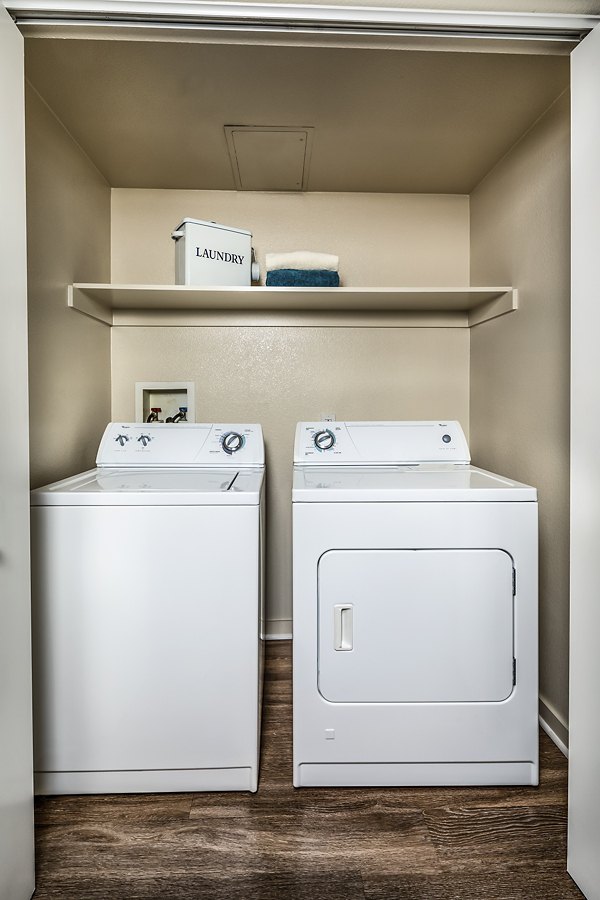 Laundry room with state-of-the-art appliances in Trio Apartments