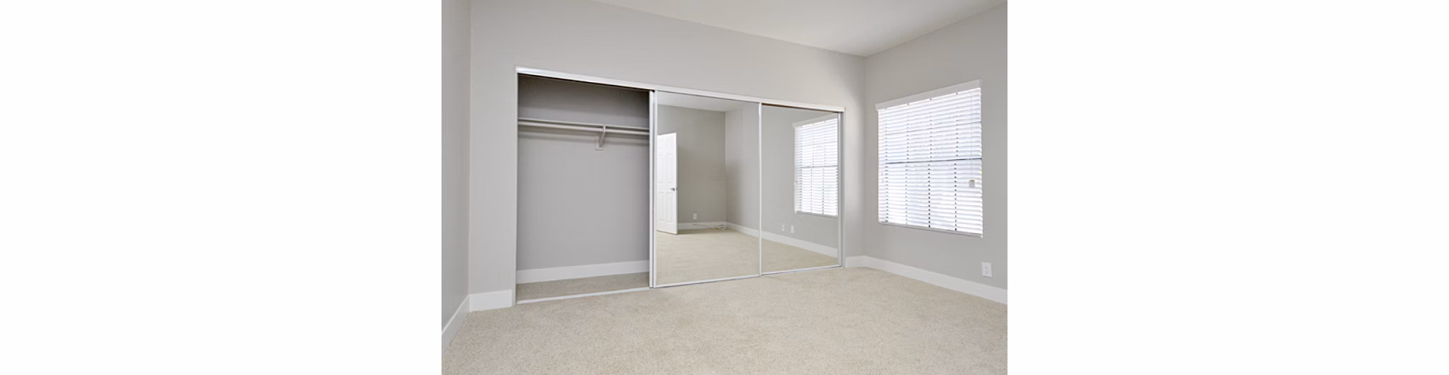 Cozy bedroom featuring chic decor and ample lighting in Westcreek Apartments