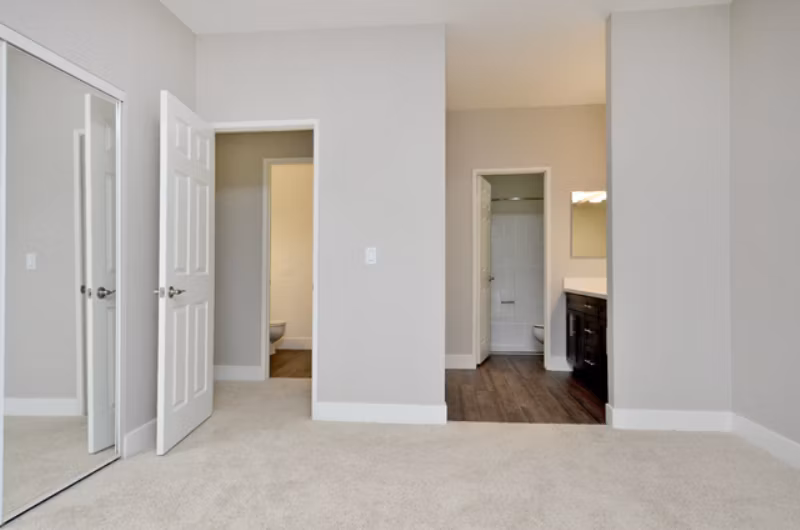 Cozy bedroom with modern furnishings in Westcreek Apartments, a Greystar luxury community in an urban setting