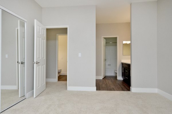 Cozy bedroom with modern furnishings in Westcreek Apartments, a Greystar luxury community in an urban setting