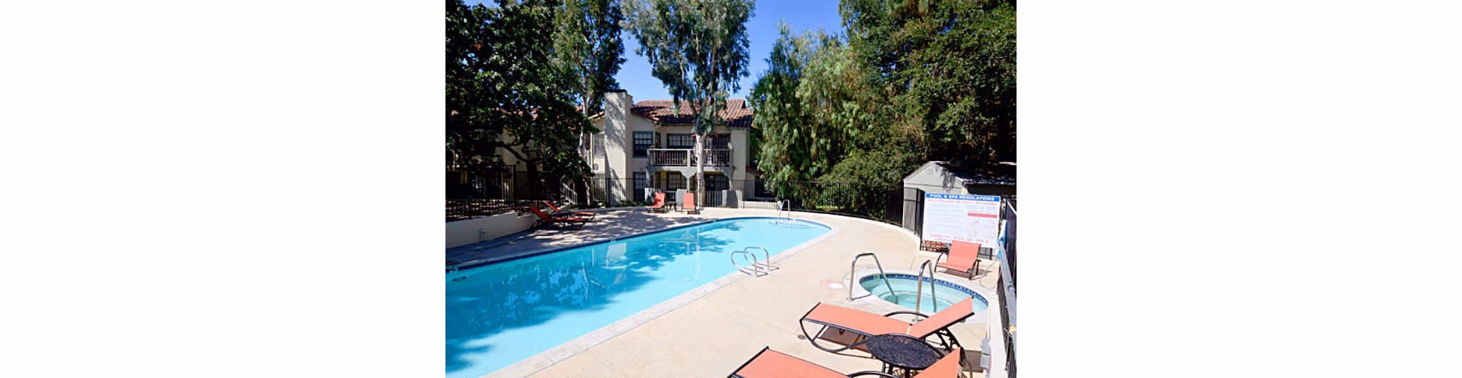 Refreshing outdoor pool at Westcreek Apartments offering lounge seating and scenic landscape Perfect for relaxing in a luxury apartment setting