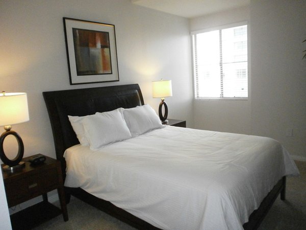 Bedroom with modern furnishings and natural light in Legacy at Westwood Apartments, luxurious living in a Greystar community